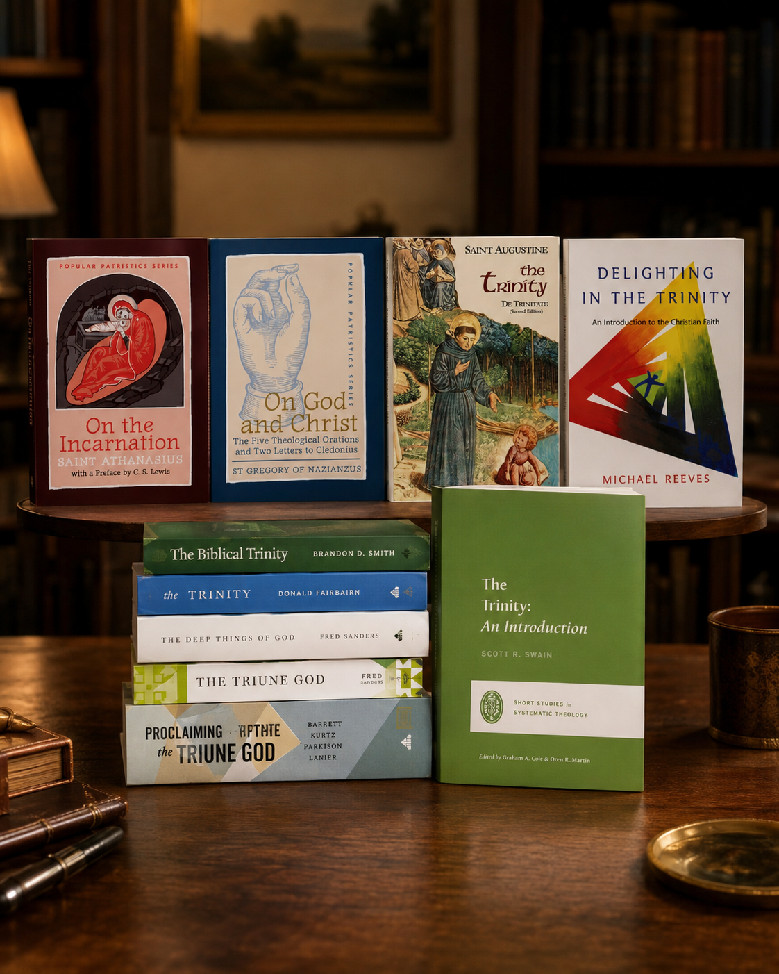 Ten hardcover theology books on the Trinity stacked on a wooden table